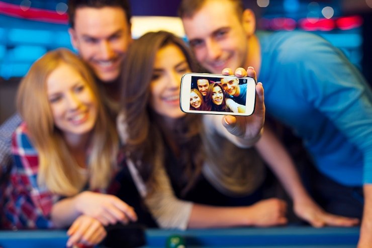 Wide overhead view of multiple live baccarat tables in a professional studio environment with real-time betting interface overlay